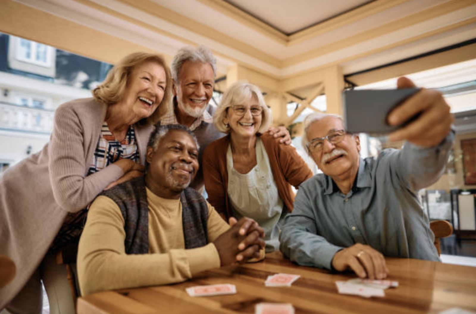 A diverse group of older Sydneysiders share a wide-grin selfie — the community Enrich Home Supports serves.