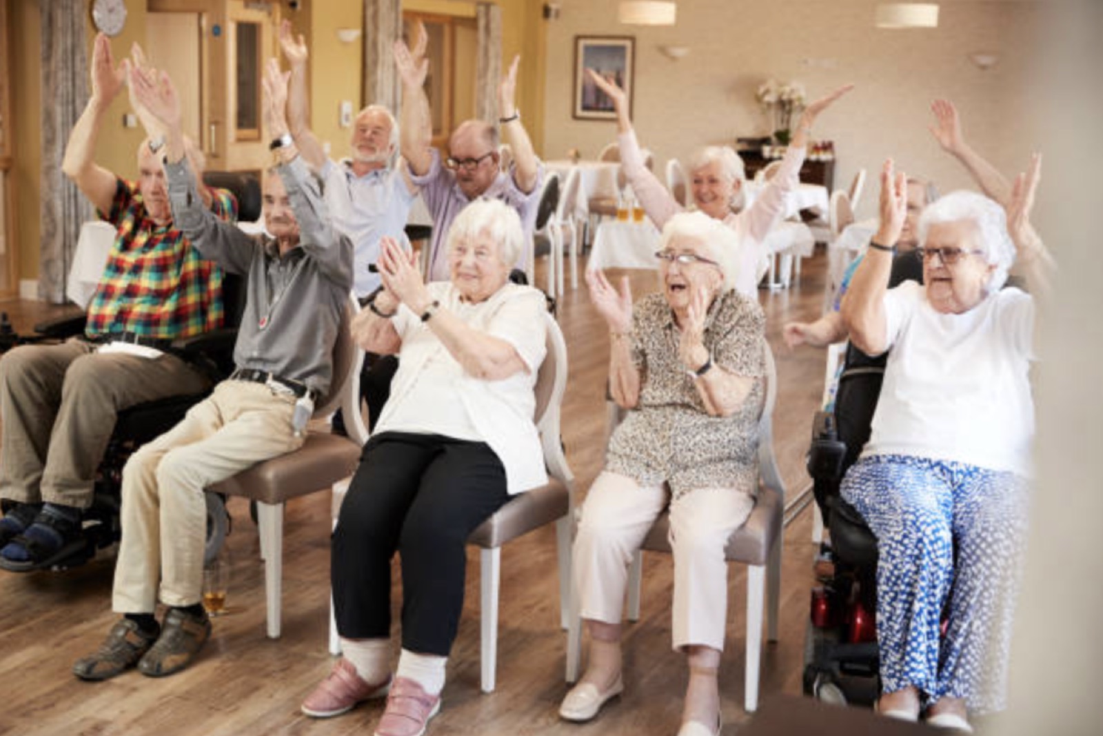 A group of older Australians in a chair-based exercise session.