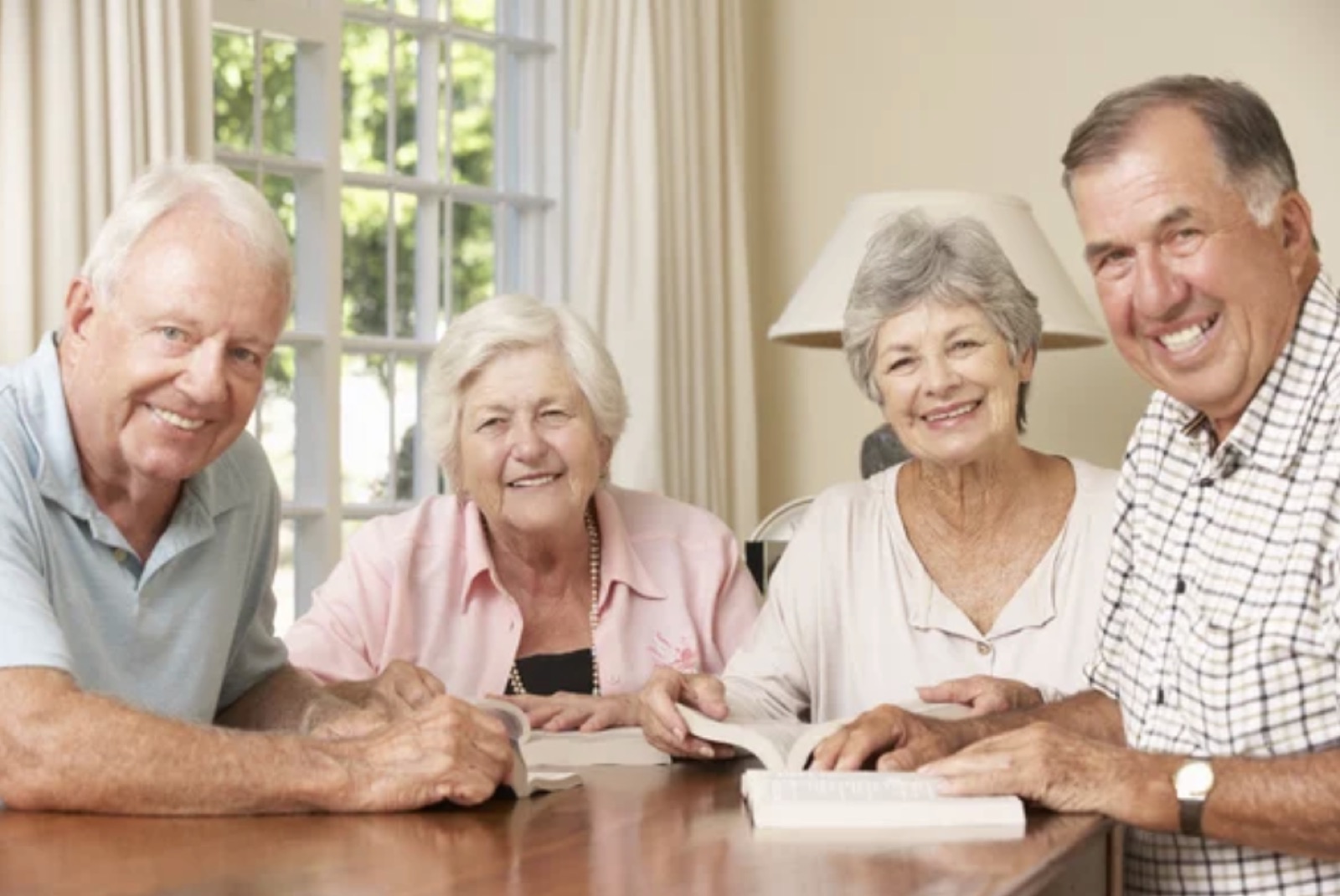 A group of older Australians around a kitchen table.